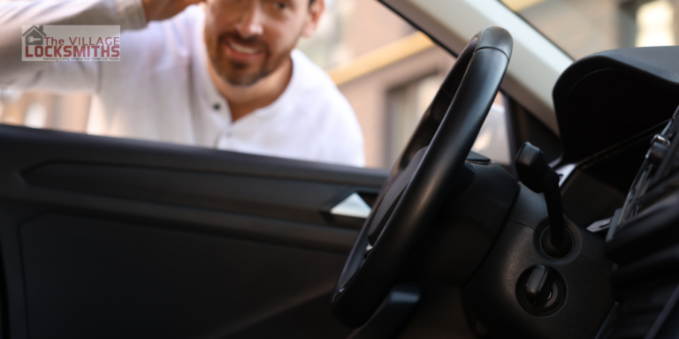 A man needing a lockout service in Amagansett, New York. He has been locked out and looking at the key inside his car through a window.